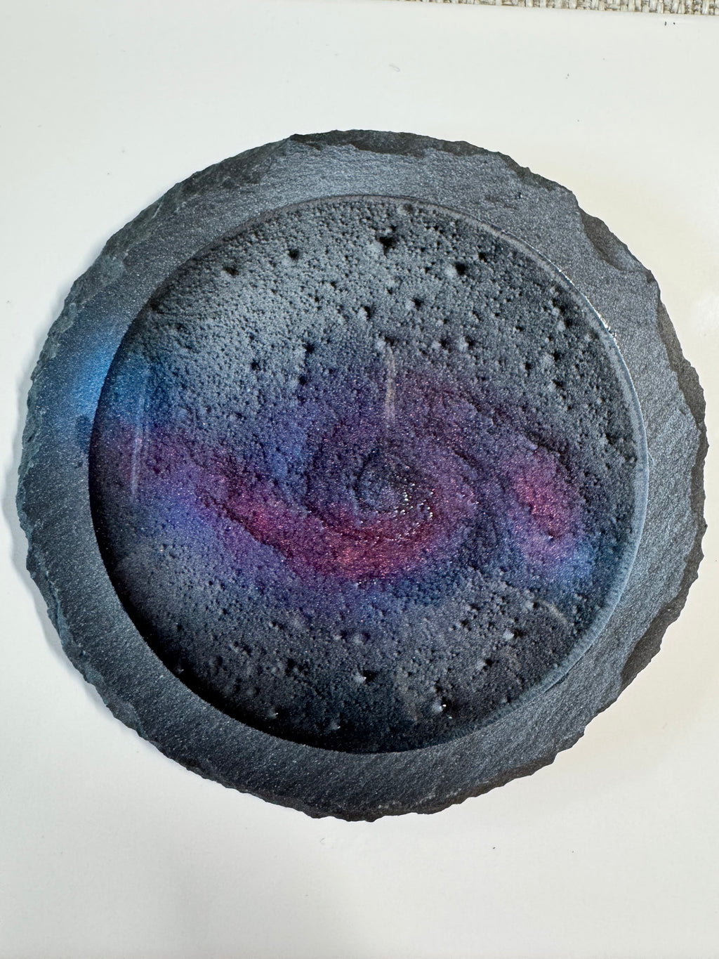 Round, textured coaster with a colourful swirl, the whirlpool galaxy